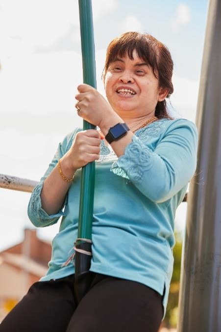 A close up of a woman smiling while on a flying fox. 